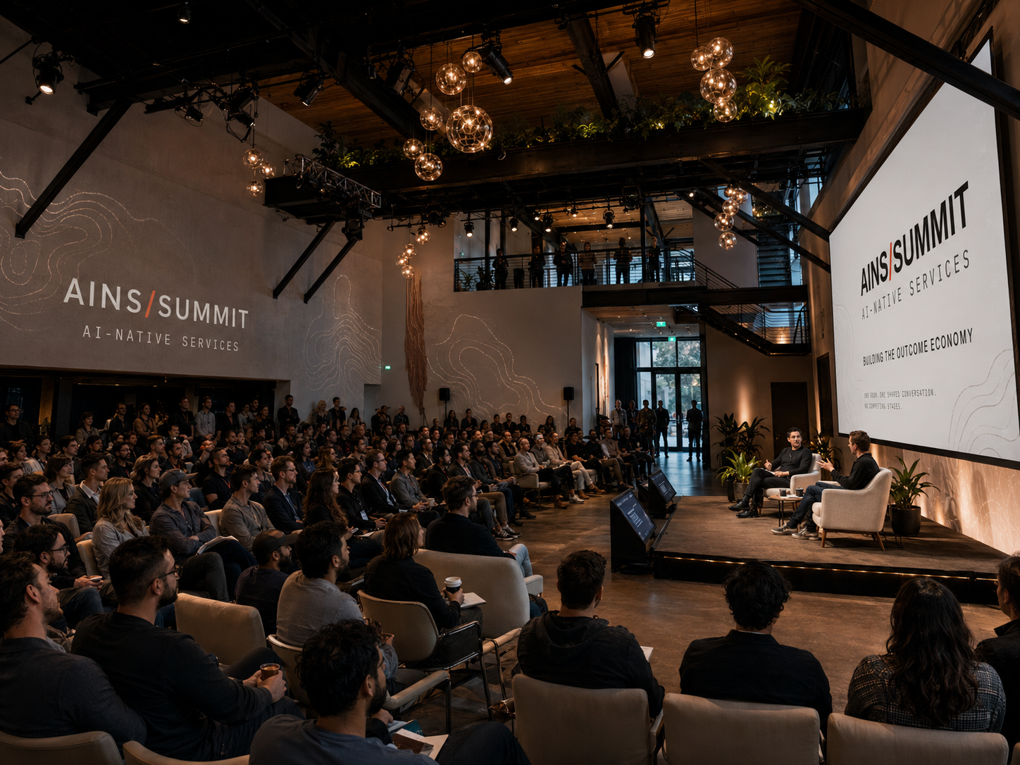 Conceptual rendering of the AINS Summit main stage at The Pearl in San Francisco: a full audience facing a fireside conversation in front of the AINS/SUMMIT stage screen.